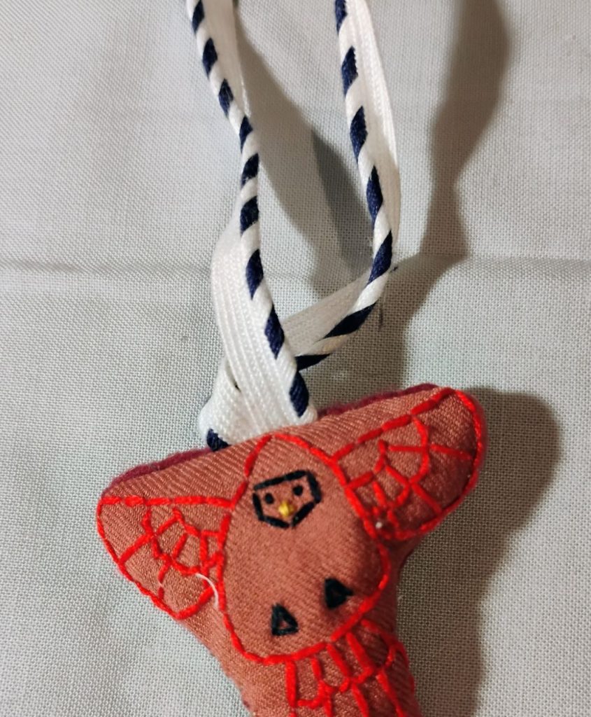 An embroidered ornament of a cardinal