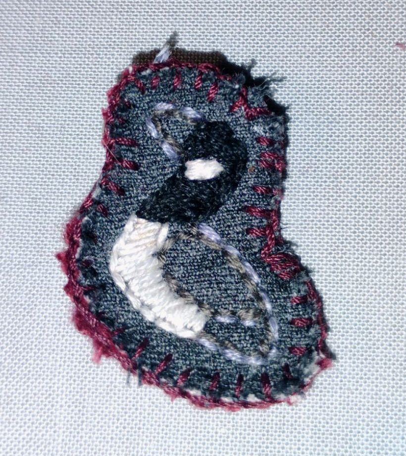 a small embroidered pin of a Canadian goose
