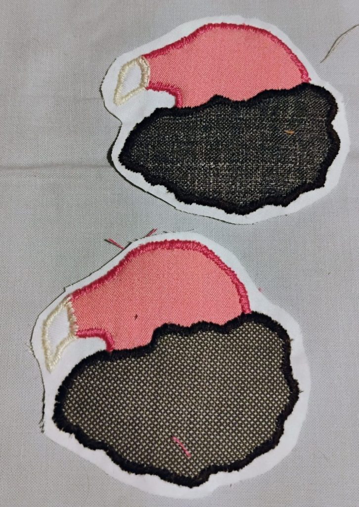 Two patches of the head of a turkey vulture. They have pink heads and white beaks with a large fluffy brown collar.